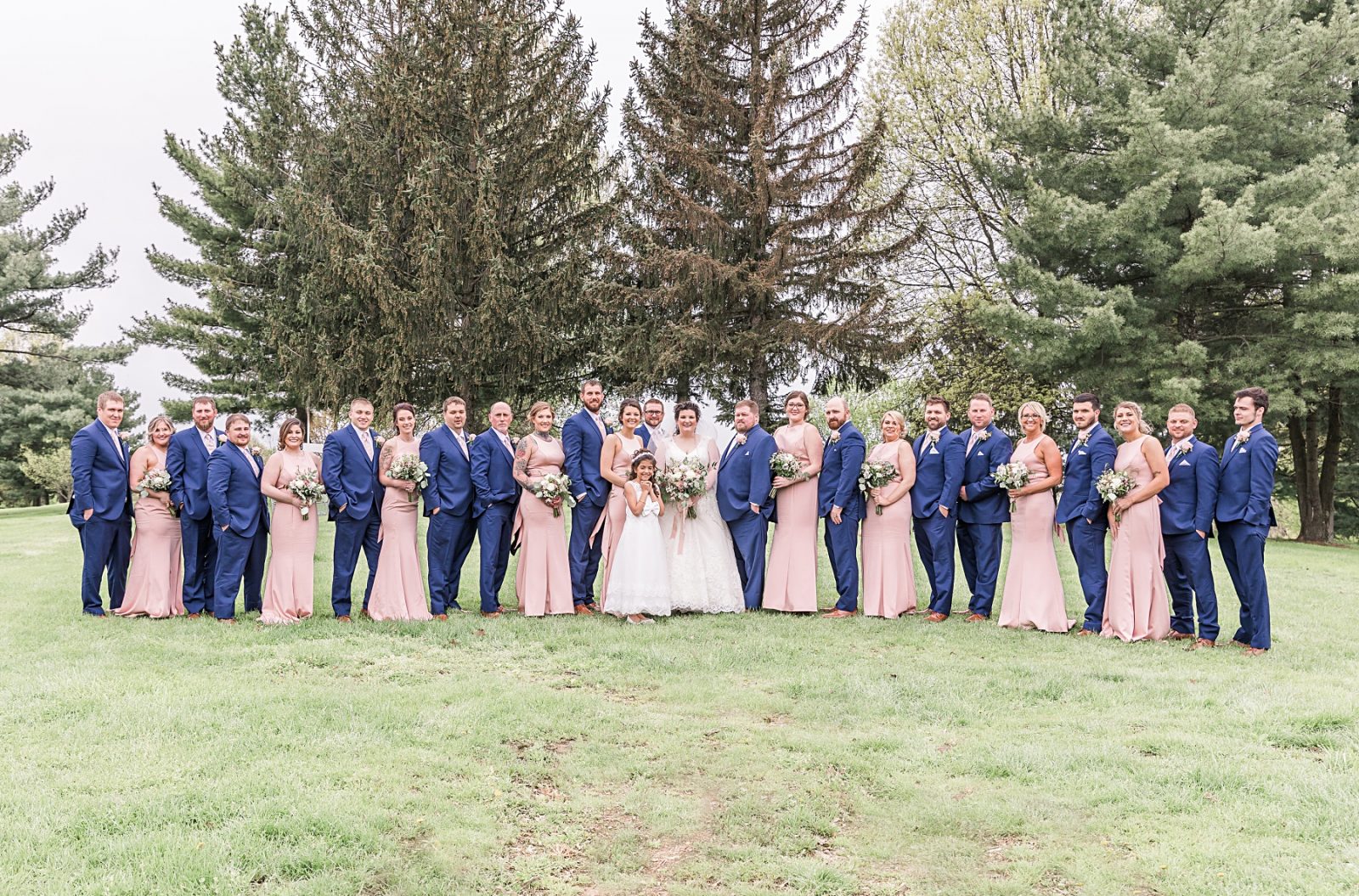 Wedding photography by Diana Gramlich, Blush and navy blue bridal party with bride and groom in front of the pine trees