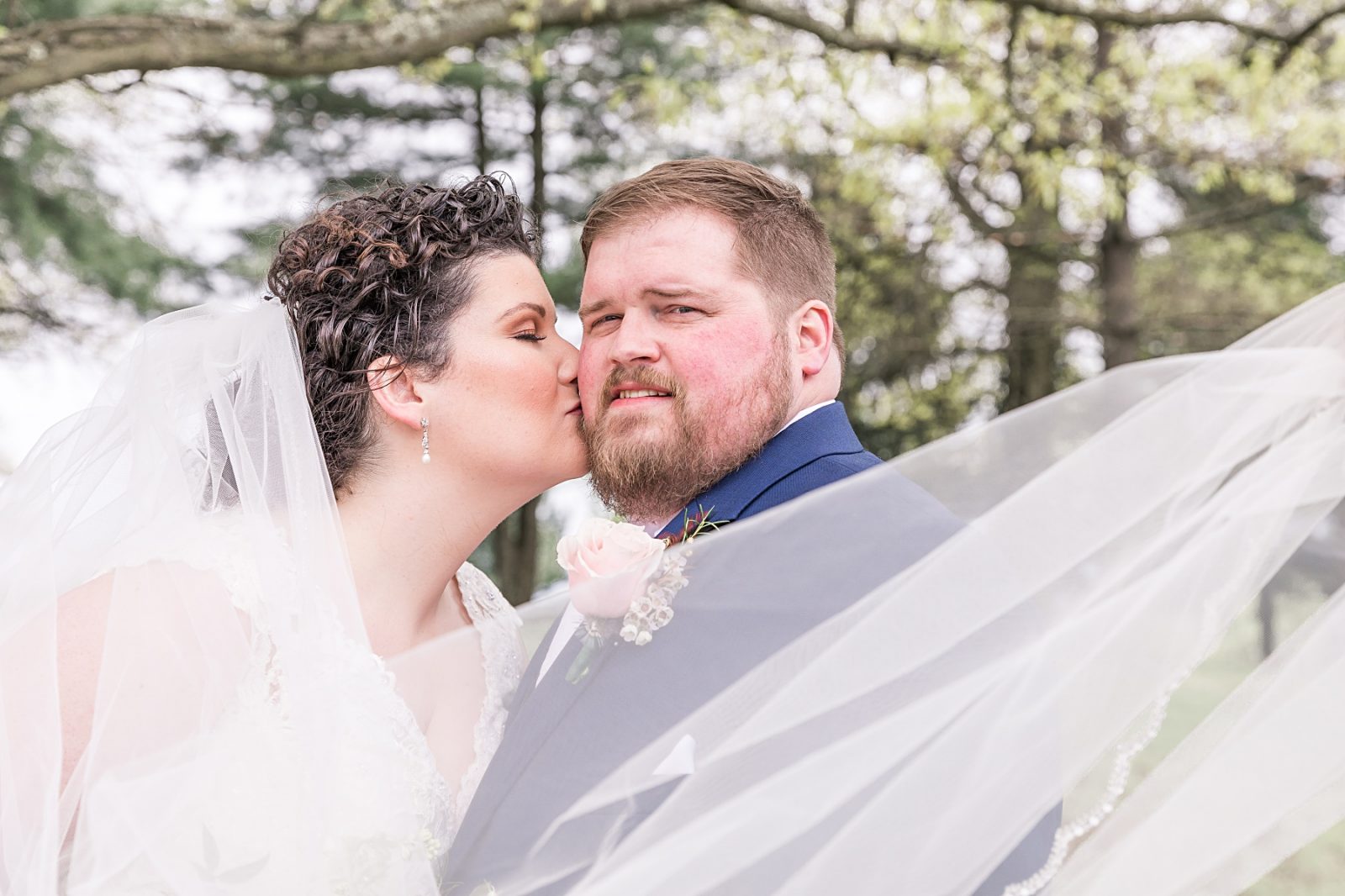 Wedding photography by Diana Gramlich, Bride kissing the groom covered by veil