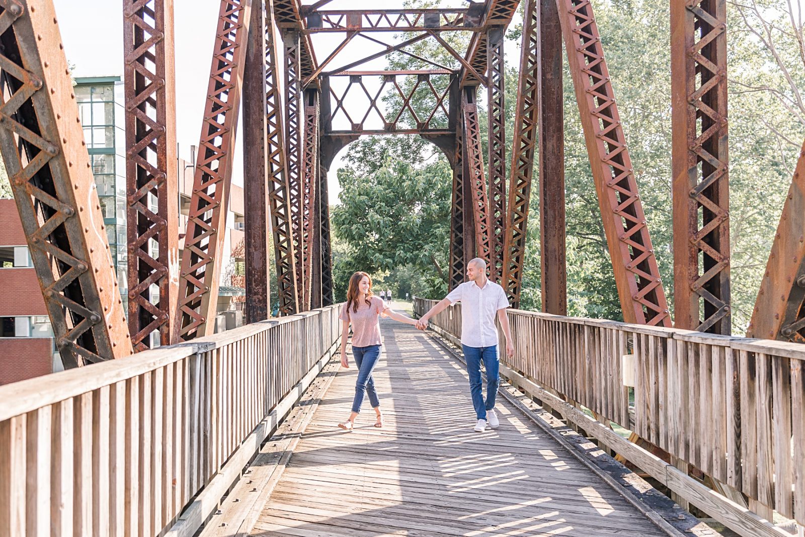 Couple walking on an old railroad bridge Morgantown Engagement Session by Diana Gramlich Photography