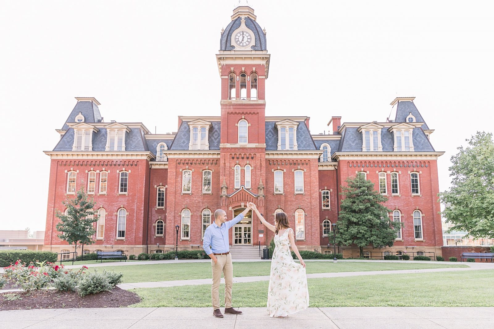 Couple is dancing in front of Woodburn Hall. Engagement Photography by Diana Gramlich 