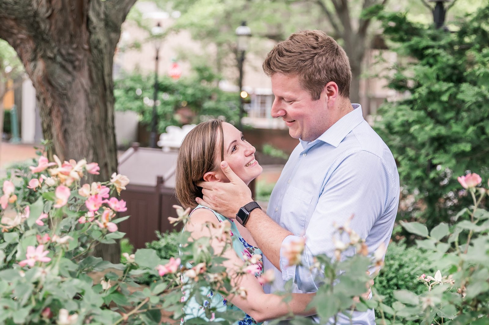 Engagement photos in downtown Canton, OH by Diana Gramlich Photography, couple looking at each other while his is touching her cheek with his hand